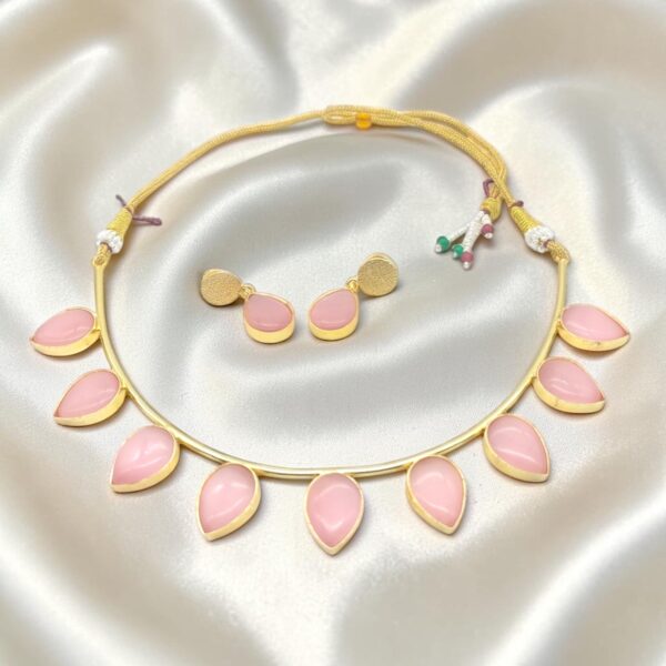 Baby Pink Monalisa Stone Brass Hasli Set with teardrop-shaped Monalisa stones, gold-plated brass hasli, matching earrings and adjustable thread closure.