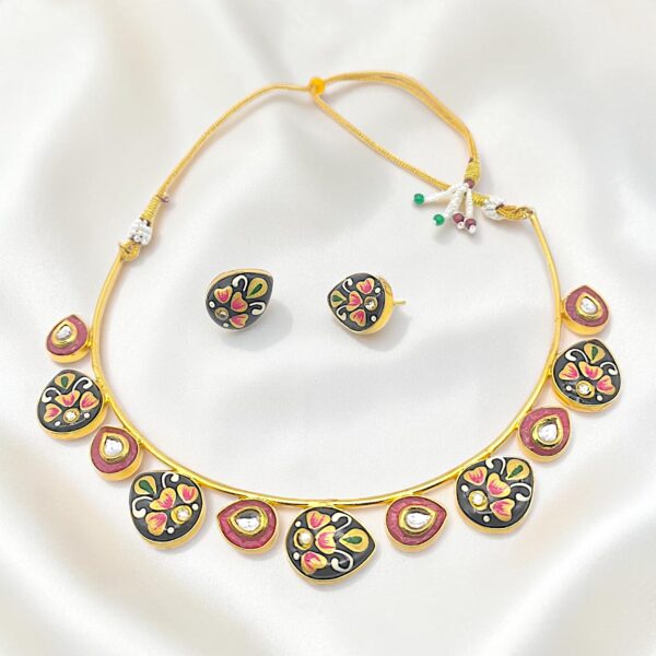 Black Hand-Painted Monalisa Stone Brass Hasli Set featuring Tanjore-inspired floral artwork on hand-painted Monalisa stones, red Monalisa stone accents, kundan-style detailing and matching earrings.