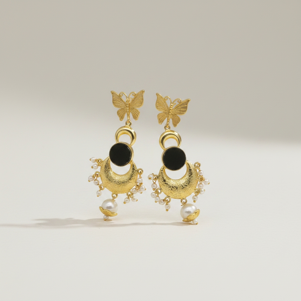 Butterfly black natural stone pearl drop earrings with glossy gold plated brass finish and pearl accents.