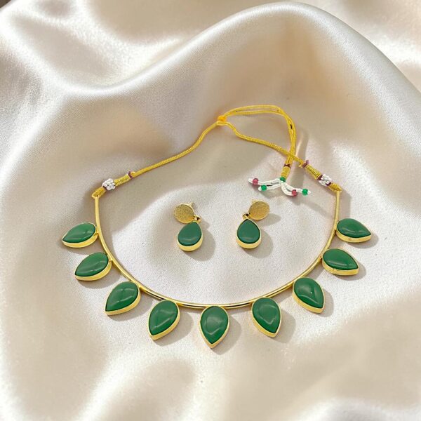 Emerald Green Monalisa Stone Brass Hasli Set with teardrop-shaped Monalisa stones, gold-plated brass hasli, matching earrings and adjustable thread closure.