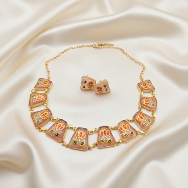 Magenta Tanjore Inspired Hand Painted Necklace Set featuring hand-painted floral motifs on magenta Monalisa stones, gold-tone finish, adjustable chain and matching stud earrings.