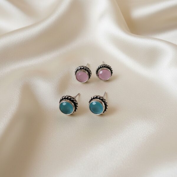 Magenta and turquoise oxidized round Monalisa stone stud earrings combo with twisted rope-style border design.