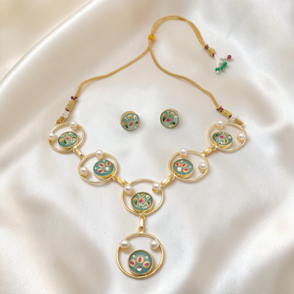 Mint Green Hand-Painted Monalisa Stone Necklace Set in gold-tone brass with Tanjore-inspired motifs, Monalisa stones, pearl accents and matching stud earrings.