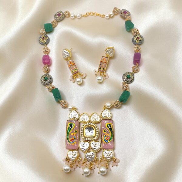 Pink hand-painted Monalisa stone Tanjore necklace set with stylised peacock artwork, natural bead stones, kundan-style detailing, heart-shaped pearl accents, artificial pearl drops and matching drop earrings.