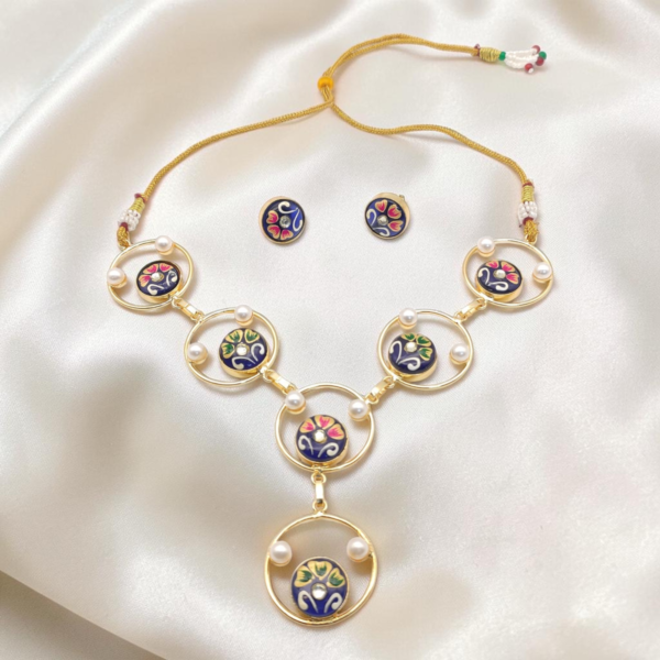 Royal Blue Hand-Painted Monalisa Stone Necklace Set in gold-tone brass with Tanjore-inspired motifs, Monalisa stones, pearl accents and matching stud earrings.