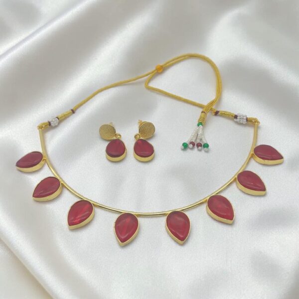 Ruby Red Monalisa Stone Brass Hasli Set with teardrop-shaped Monalisa stones, gold-plated brass hasli, matching earrings and adjustable thread closure.