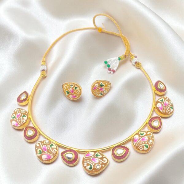Yellow Hand-Painted Monalisa Stone Brass Hasli Set featuring Tanjore-inspired floral artwork on hand-painted Monalisa stones, red Monalisa stone accents, kundan-style detailing and matching earrings.